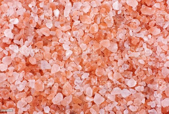 Pink himalayan salt background. Close up.